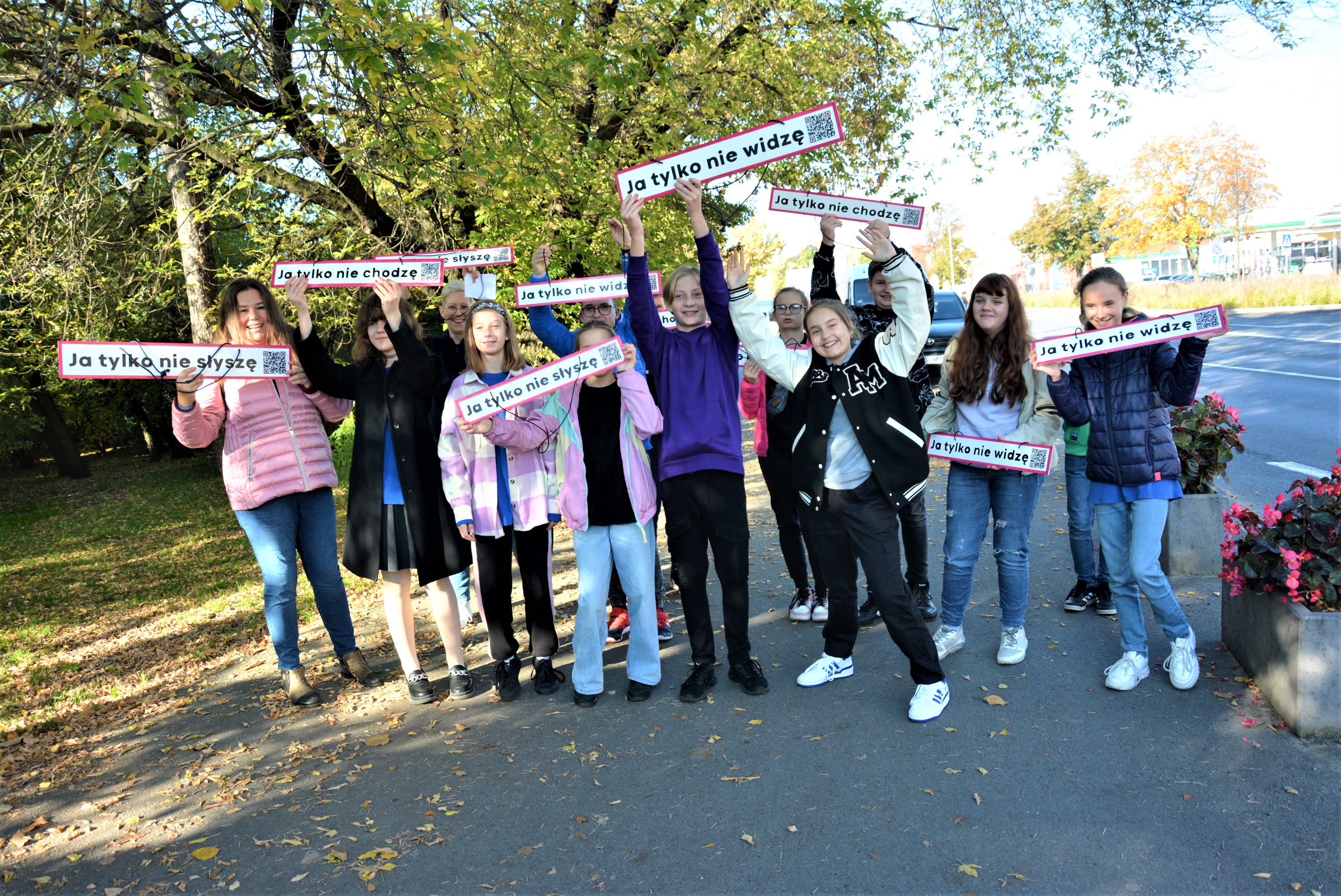 Campaign photo - young people with signs about the project